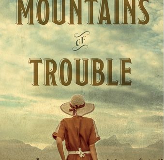 Cover art for Mountains of Trouble. Woman in red dress looking toward mountains.