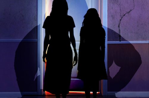 Two girls in silhouette in front of a cracked wall. Stay Out of That Room cover art.